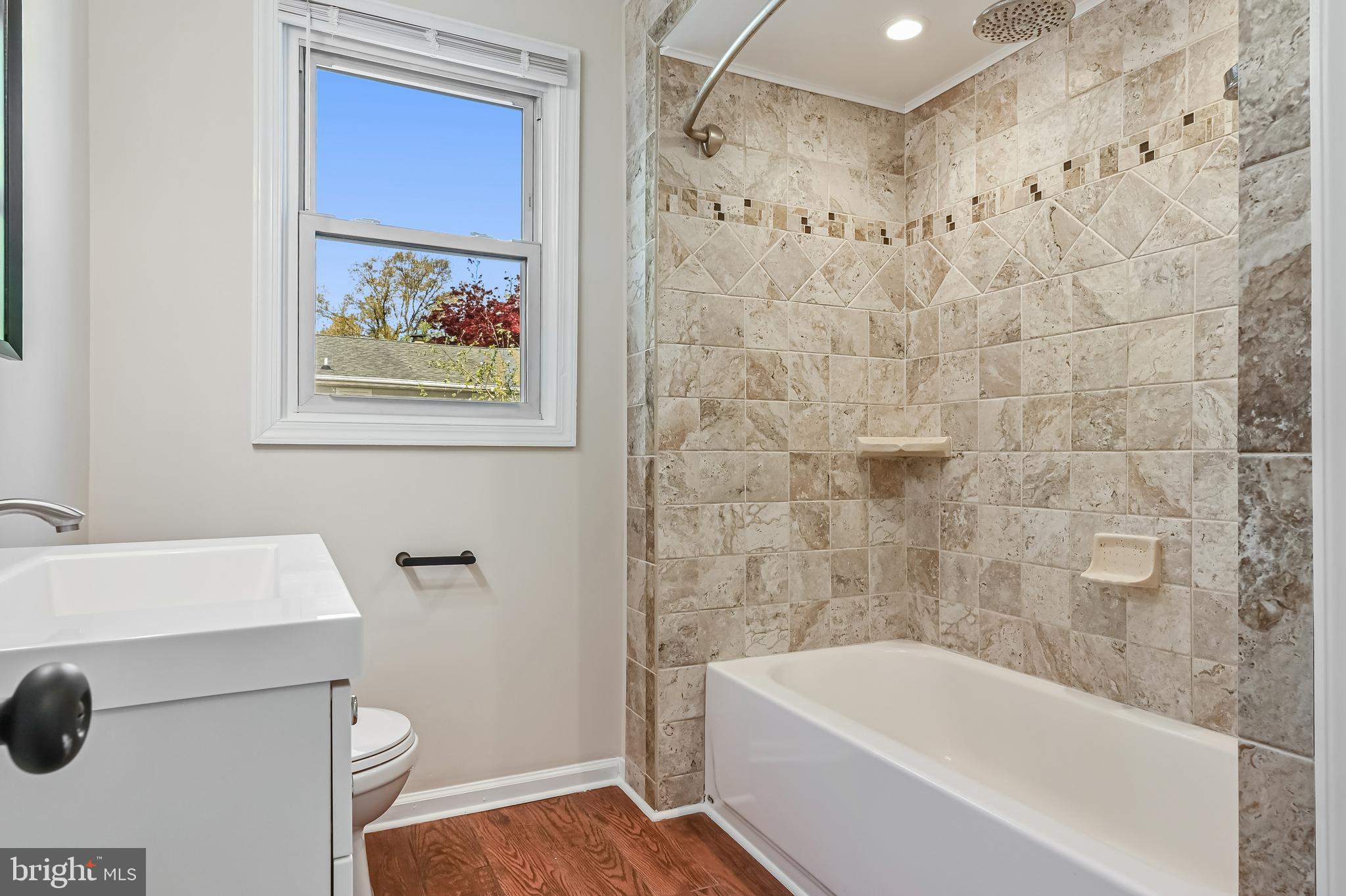 313 Orchard Road Edgewater, MD 21037 - Photo 14 of 48 a bathroom with a sink a bathtub and a toilet