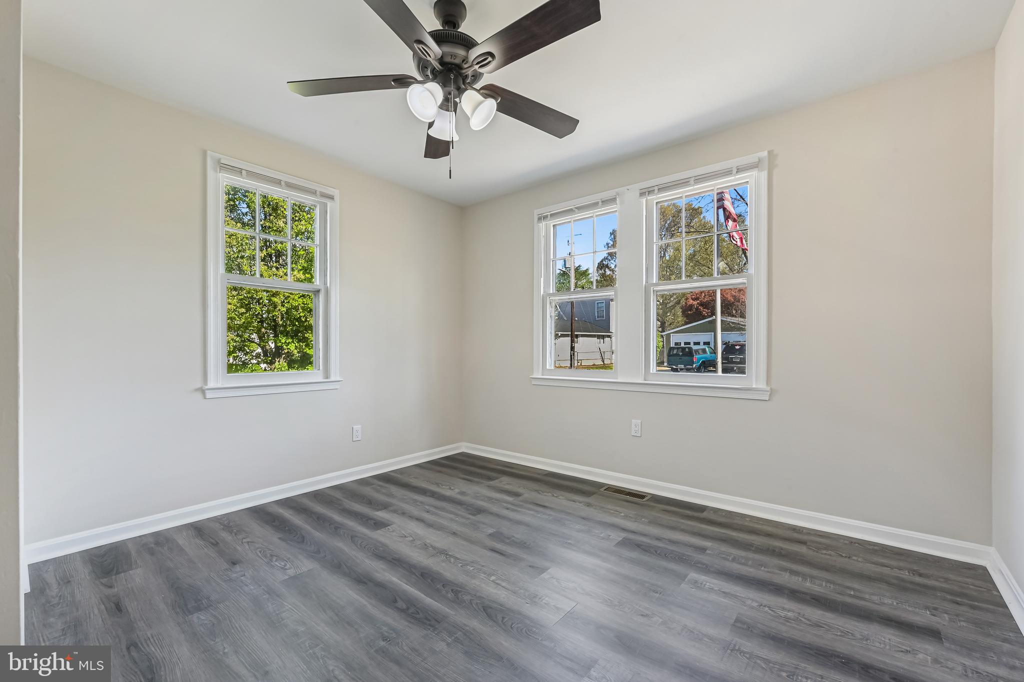 313 Orchard Road Edgewater, MD 21037 - Photo 17 of 48 a view of an empty room with wooden floor and a window