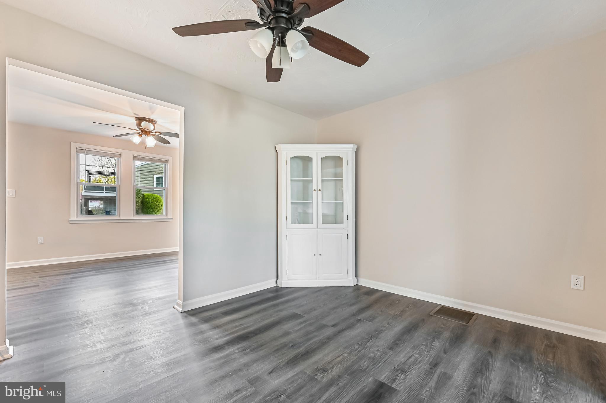 313 Orchard Road Edgewater, MD 21037 - Photo 26 of 48 an empty room with wooden floor chandelier fan and windows