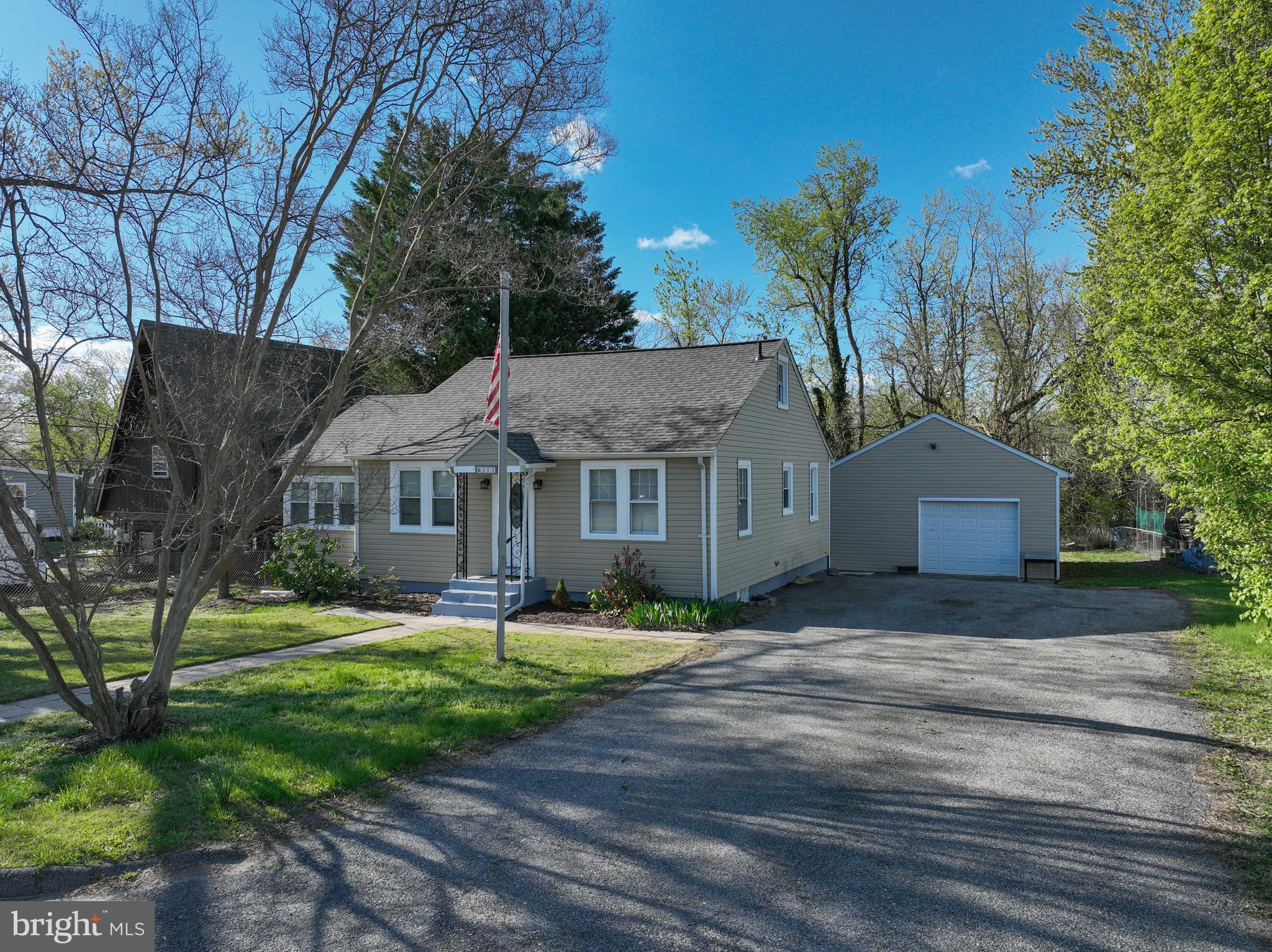 313 Orchard Road Edgewater, MD 21037 - Photo 3 of 48 a front view of a house with a yard and large tree