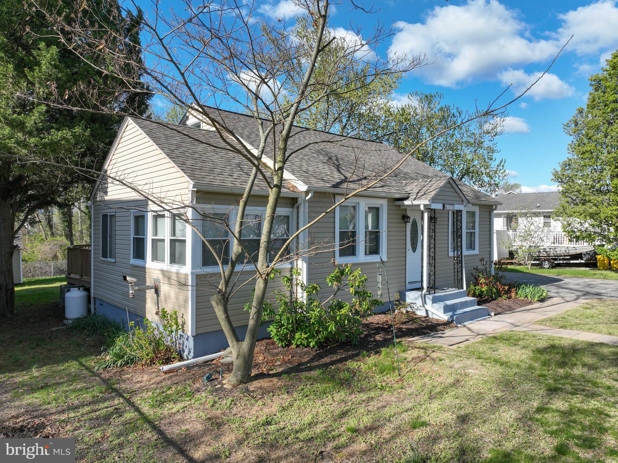 313 Orchard Road Edgewater, MD 21037 - Photo 5 of 48 a view of a house with a yard and sitting area