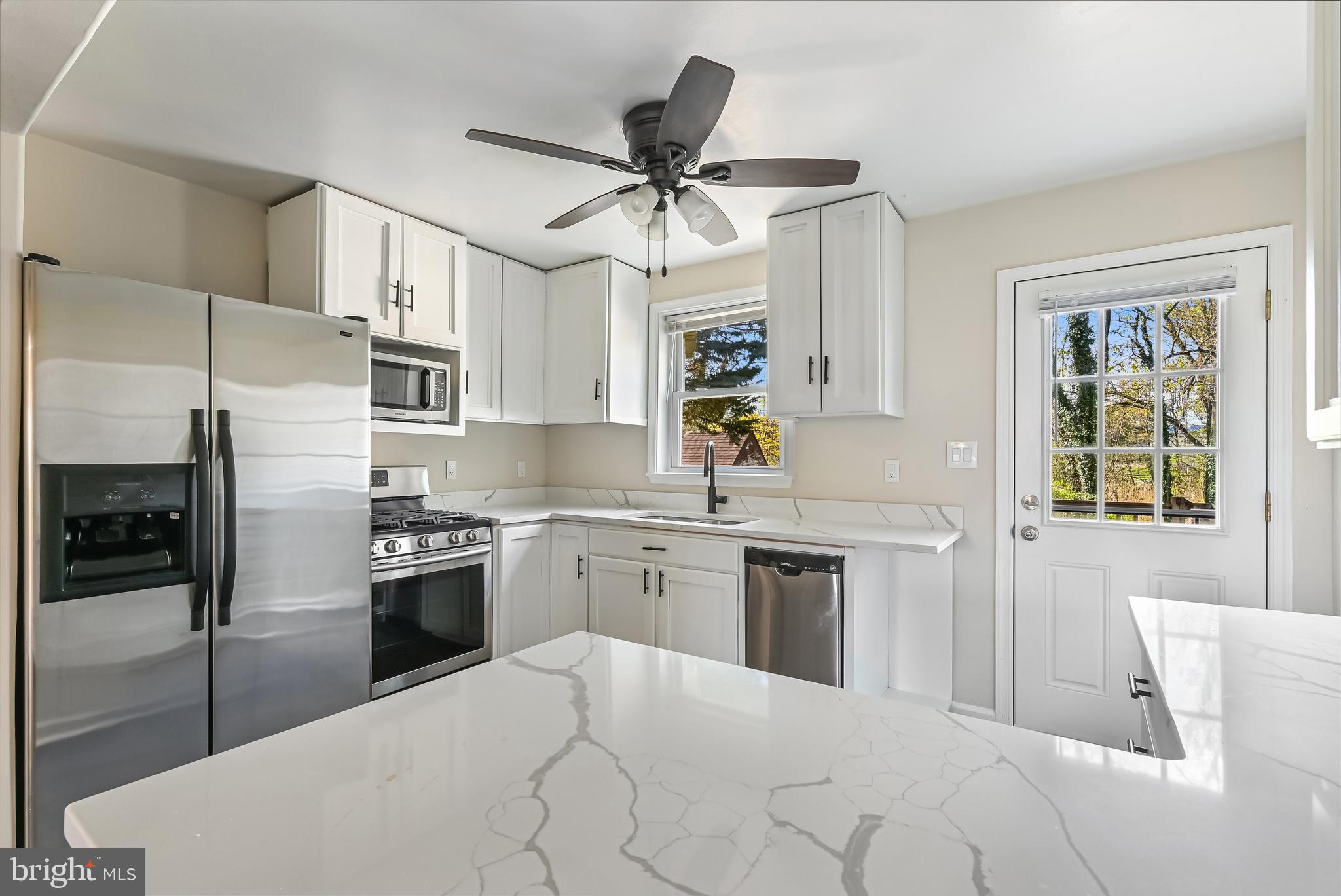 313 Orchard Road Edgewater, MD 21037 - Photo 8 of 48 a kitchen with stainless steel appliances kitchen island granite countertop a stove a sink dishwasher and a refrigerator with wooden floor