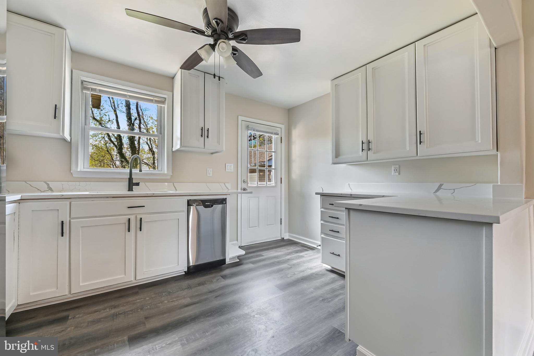 313 Orchard Road Edgewater, MD 21037 - Photo 9 of 48 a kitchen with white cabinets and a sink