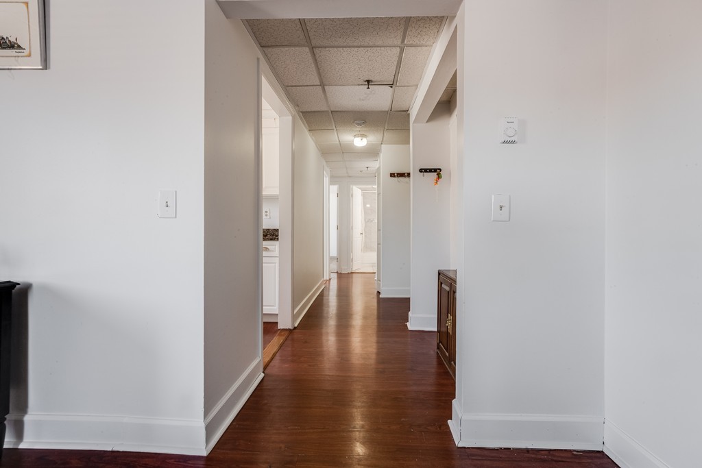 111 Foster Street, Unit 401 Peabody, MA 01960 - Photo 3 of 8 a view of a hallway with wooden floor and closet