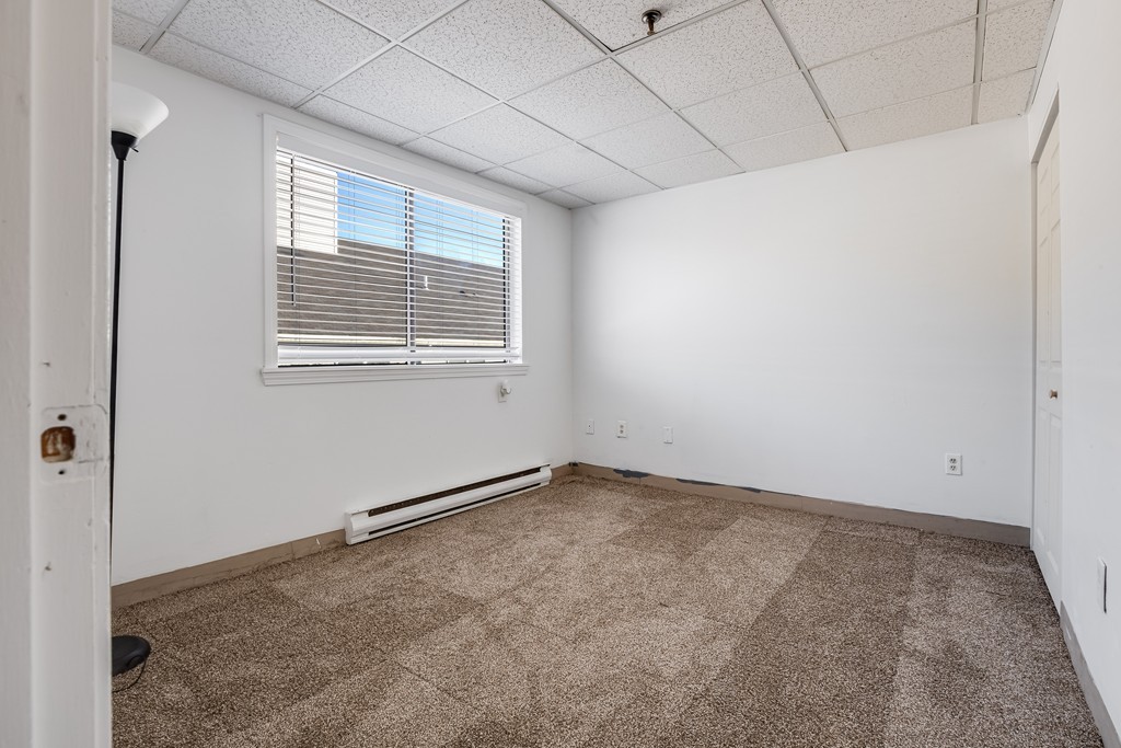 111 Foster Street, Unit 401 Peabody, MA 01960 - Photo 8 of 8 a view of an empty room with a window