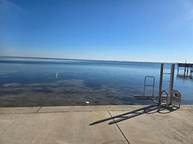 a view of a balcony with chairs and wooden floor