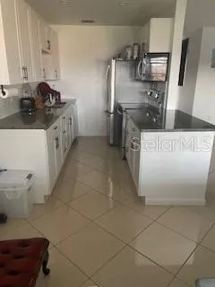 a kitchen with stainless steel appliances a sink a stove and a refrigerator