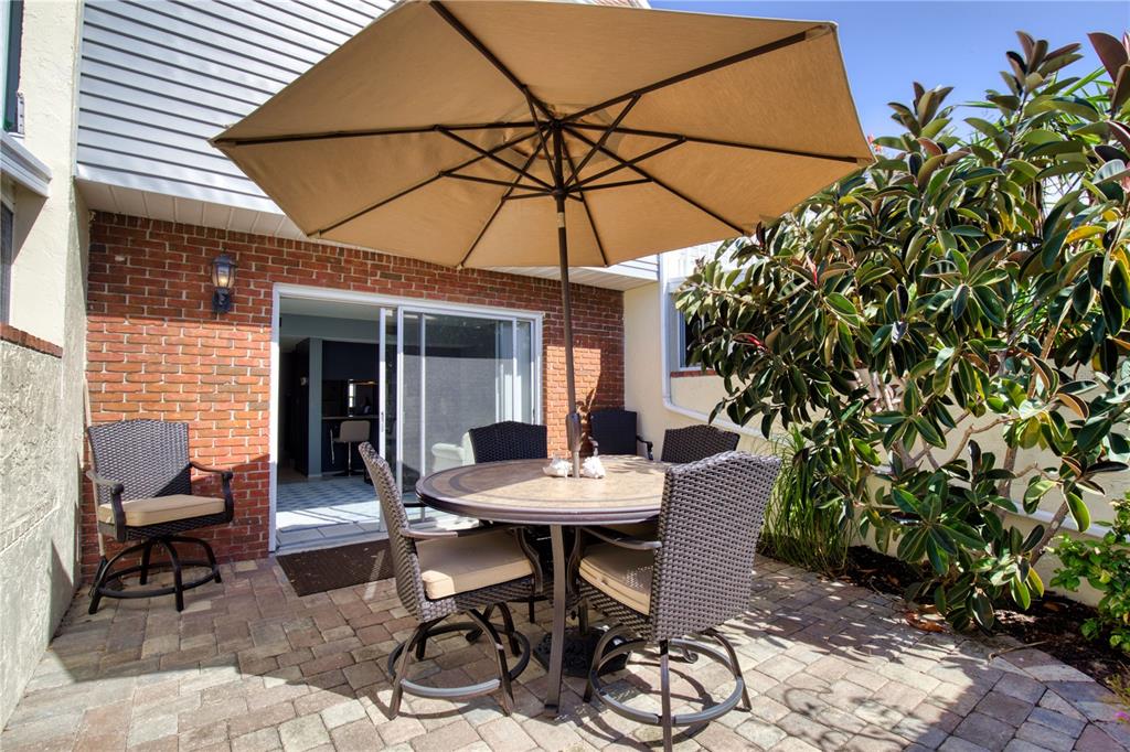 744 Cadiz Road, Unit 2 Venice, FL 34285 - Photo 11 of 26 a view of a tables and chairs under an umbrella