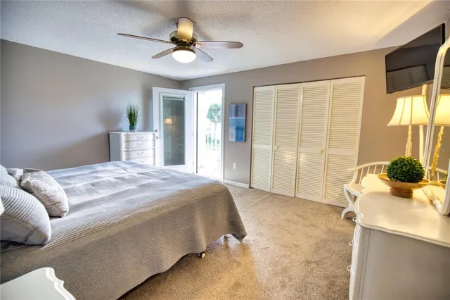 a spacious bedroom with a bed and a chandelier
