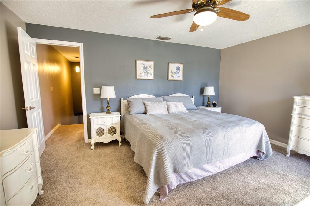 744 Cadiz Road, Unit 2 Venice, FL 34285 - Photo 18 of 26 a bedroom with a bed and a chandelier