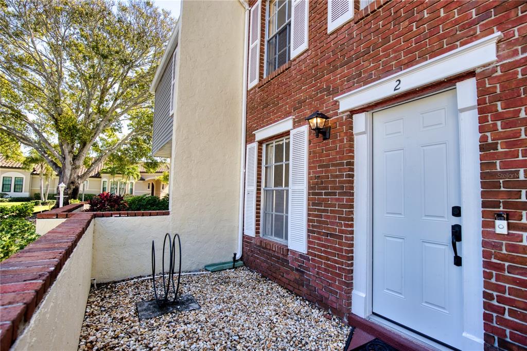 744 Cadiz Road, Unit 2 Venice, FL 34285 - Photo 2 of 26 a front view of a house with a yard