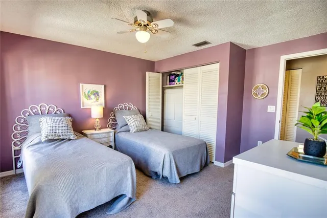 a spacious bedroom with two beds and a chandelier
