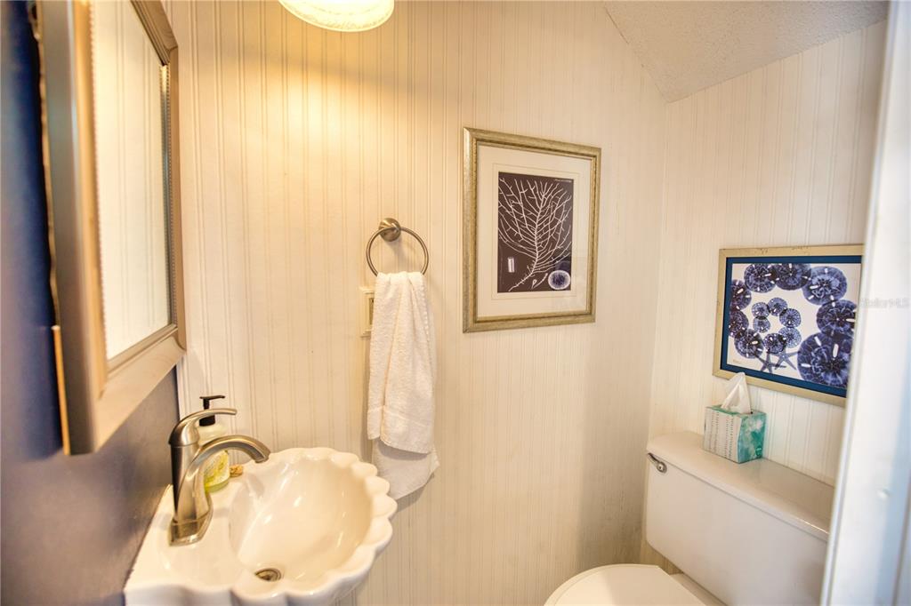 744 Cadiz Road, Unit 2 Venice, FL 34285 - Photo 24 of 26 a bathroom with a toilet sink and mirror