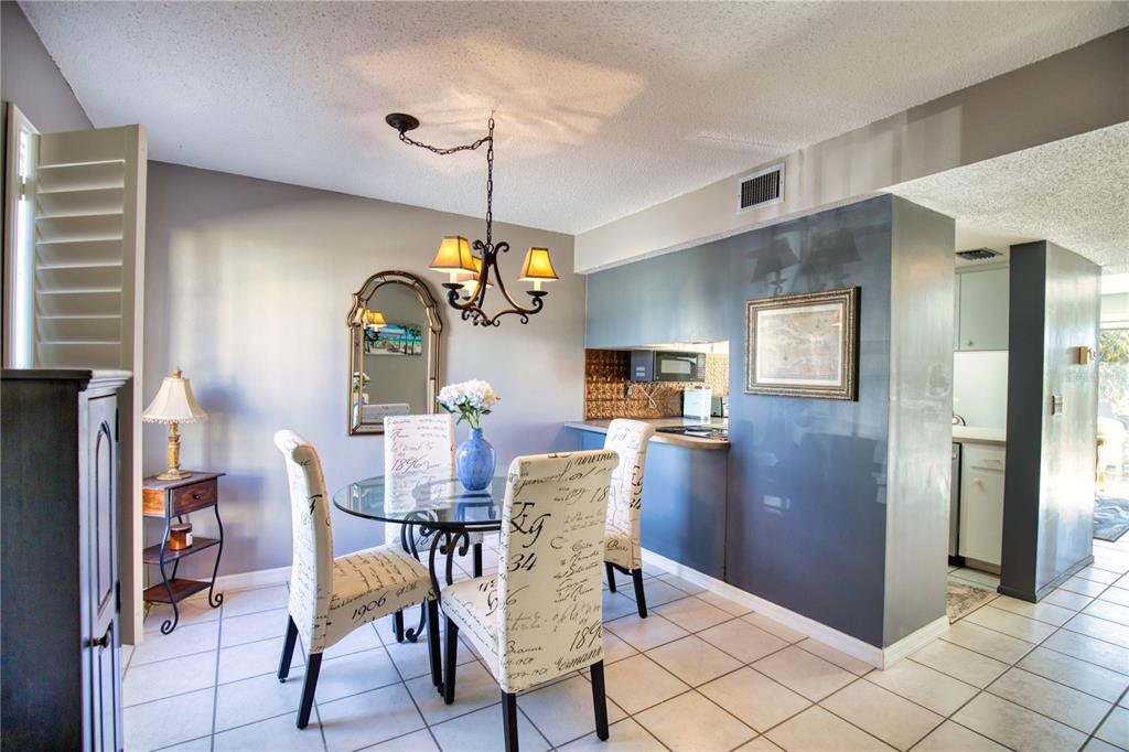 744 Cadiz Road, Unit 2 Venice, FL 34285 - Photo 3 of 26 a view of a dining room with furniture window and wooden floor
