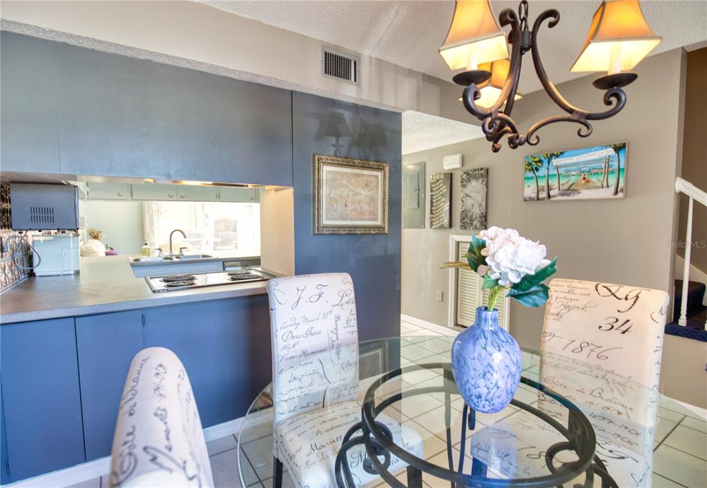 744 Cadiz Road, Unit 2 Venice, FL 34285 - Photo 5 of 26 a dining room with furniture potted plants and wooden floor