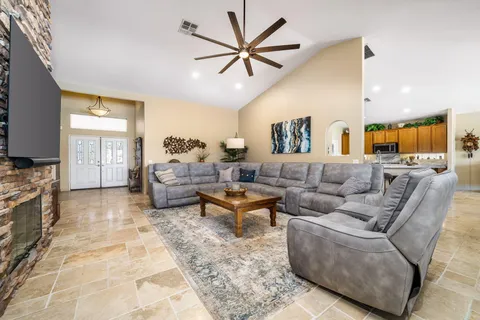 a living room with furniture ceiling fan and a rug
