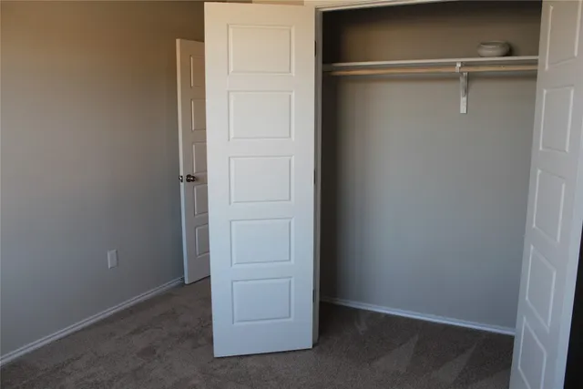 a bathroom with a granite countertop bathtub sink vanity mirror and toilet