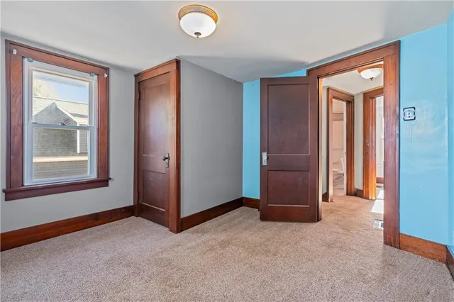 an empty room with windows and closet