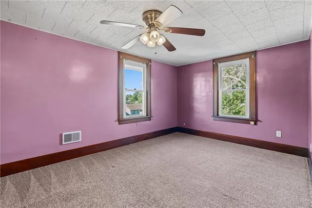 a view of a livingroom with a window and a ceiling fan