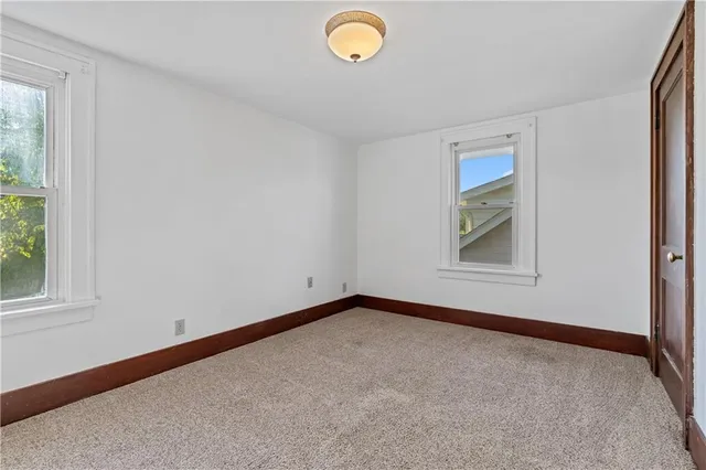 an empty room with windows and closet
