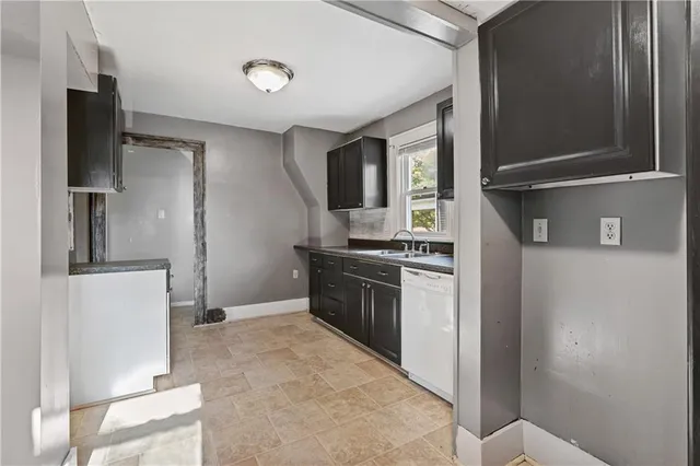 a kitchen with stainless steel appliances granite countertop a refrigerator and a stove