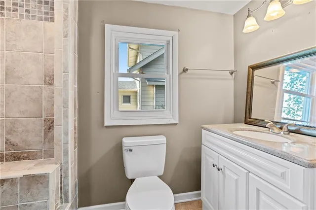 a bathroom with a toilet sink and mirror