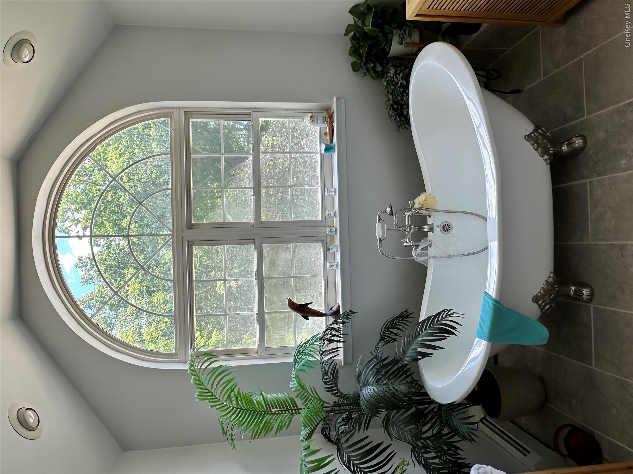 95 Weed Road Pine Bush, NY 12566 - Photo 15 of 31 Freestanding clawfoot tub with a polished chrome faucet and showerhead