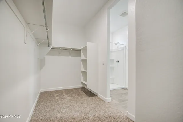 a bathroom with a sink a toilet a mirror and shower