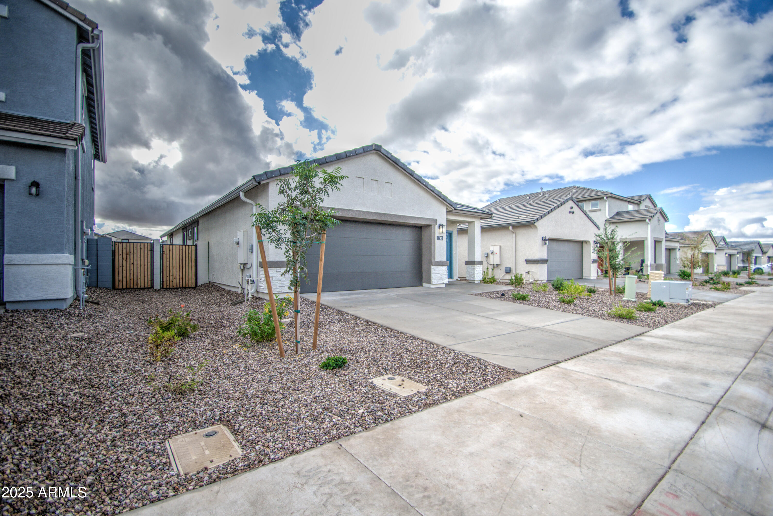 1749 West Stealth Avenue Apache Junction, AZ 85120 - Photo 4 of 48 a front view of a house with garden and plants