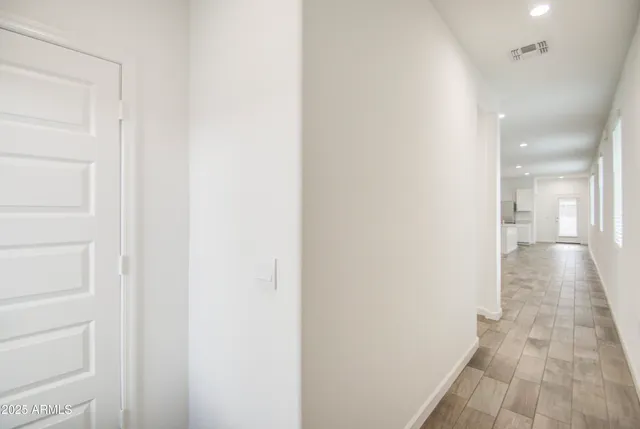 a view of a hallway with wooden floor