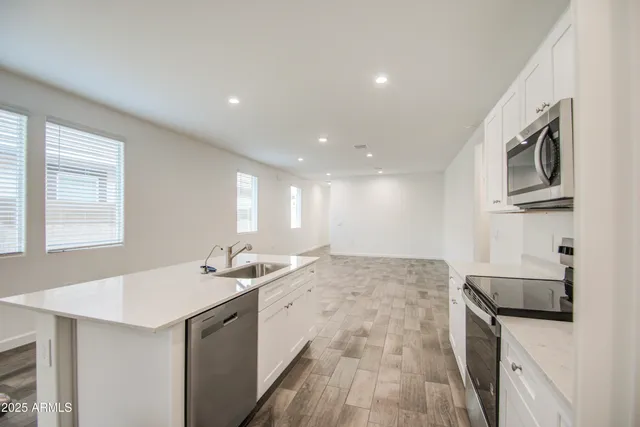 a kitchen with a sink stove and microwave