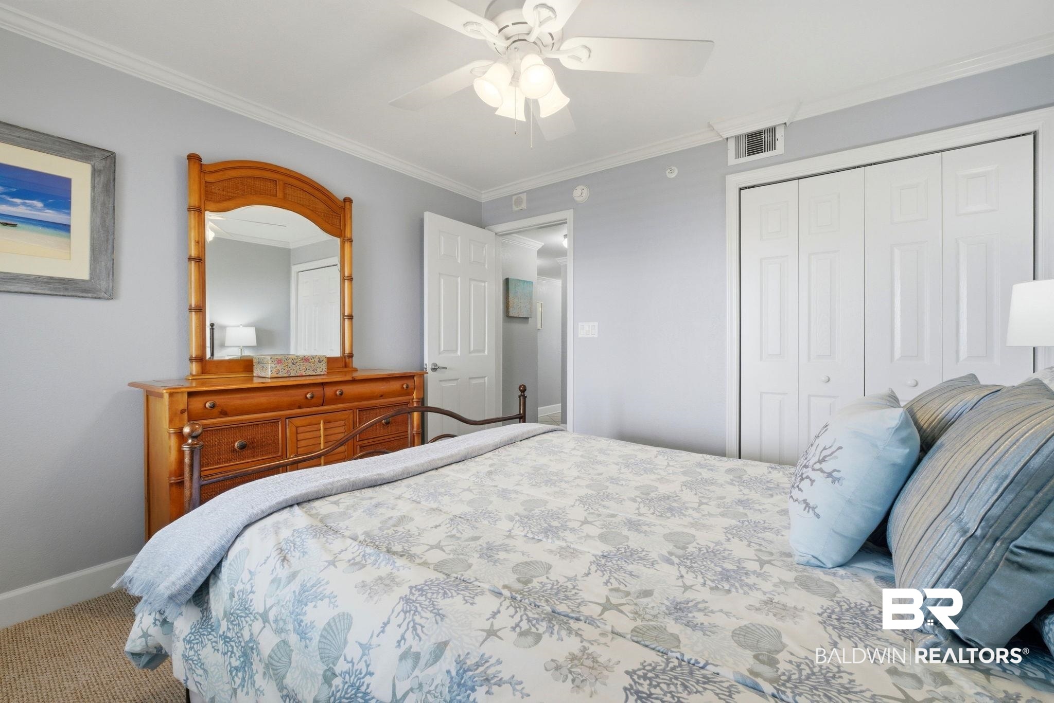 16284 Perdido Key Drive, Unit 912 Perdido Key, FL 32507 - Photo 36 of 49 Carpeted bedroom featuring a closet, ceiling fan, and crown molding