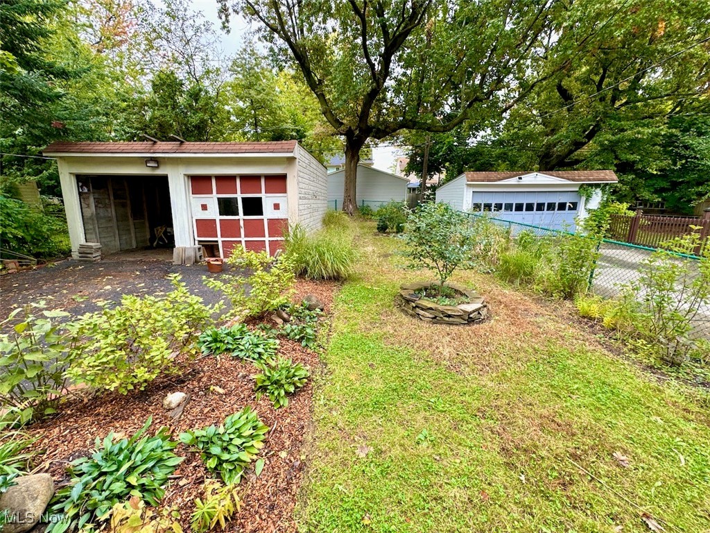 1011 Rushleigh Road Cleveland, OH 44121 - Photo 25 of 27 View of yard with an outdoor structure and a garage