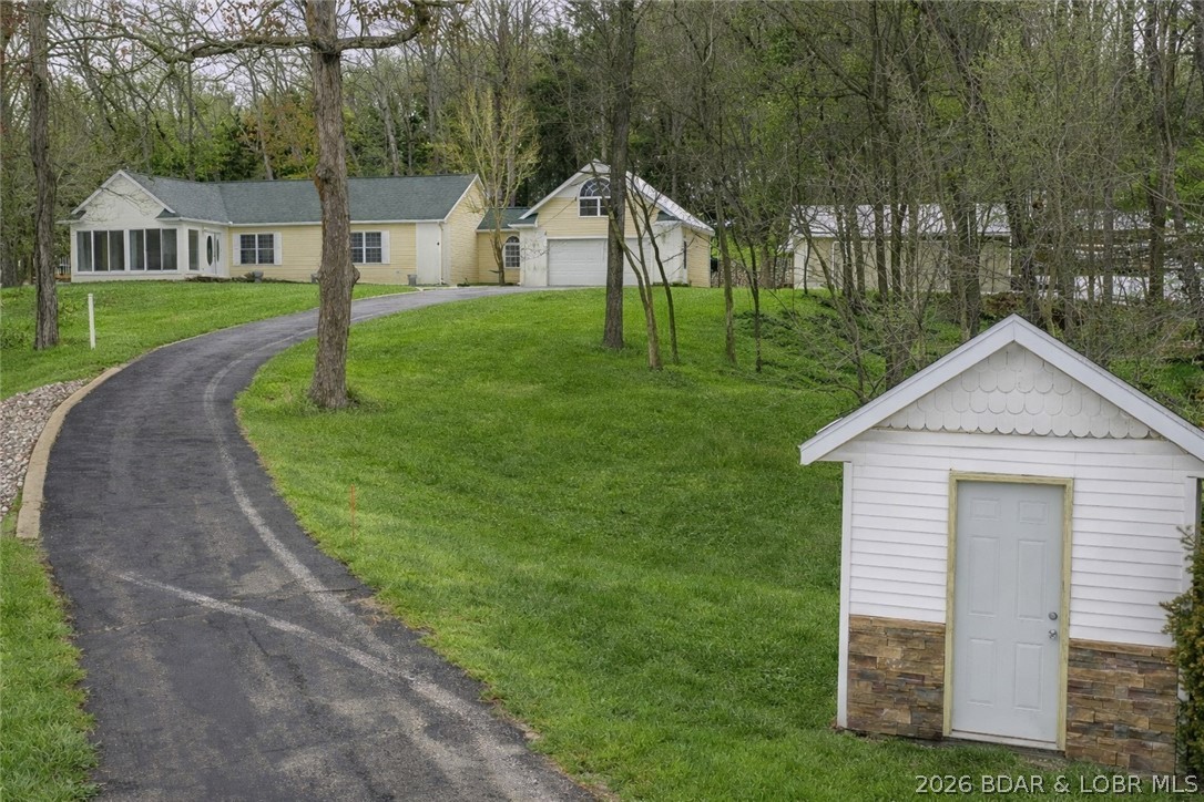 Long private drive leads to this gorgeous home