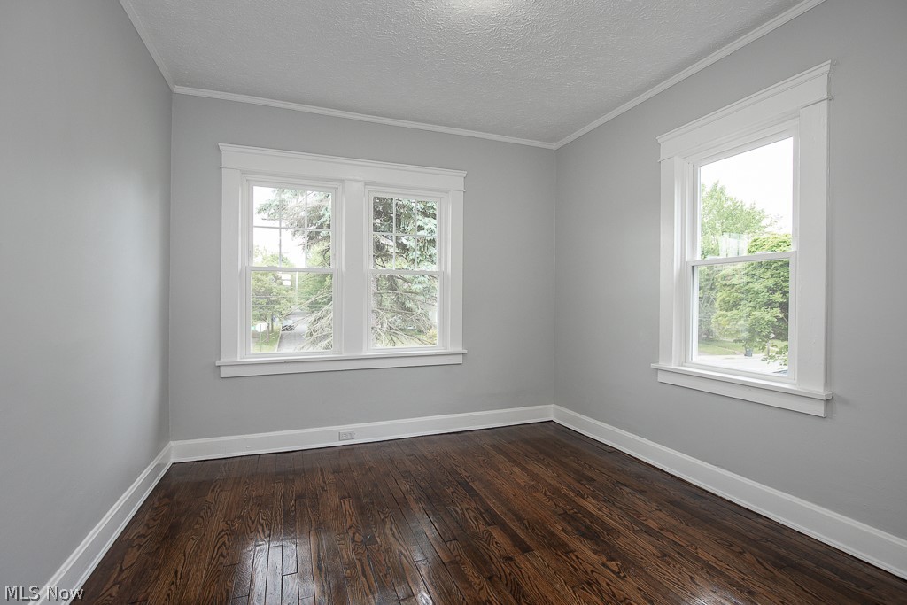 13131 Cedar Road Cleveland, OH 44118 - Photo 14 of 23 Unfurnished room with a healthy amount of sunlight, hardwood / wood-style flooring, and a textured ceiling