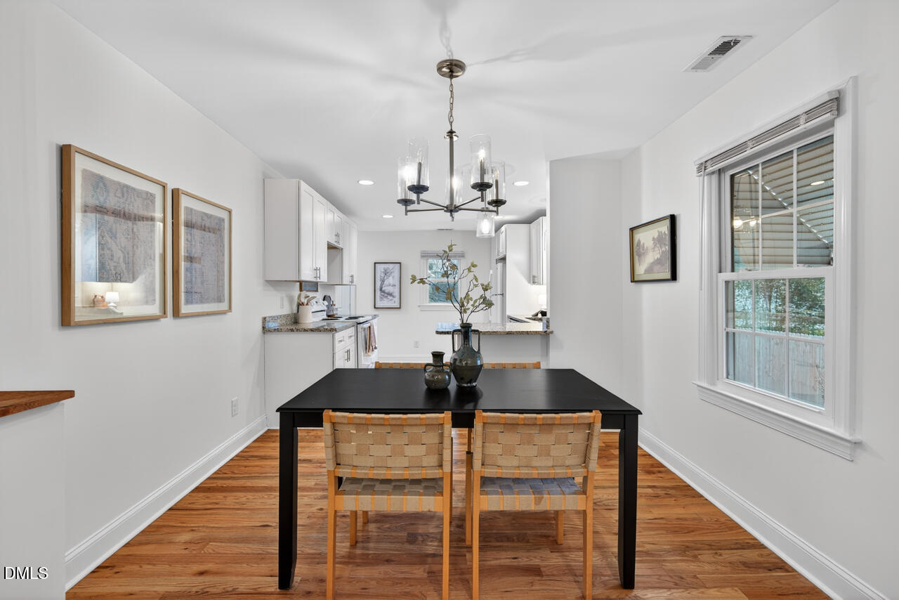 802 Cox Avenue Durham, NC 27701 - Photo 11 of 41 a table room with wooden floor and windows