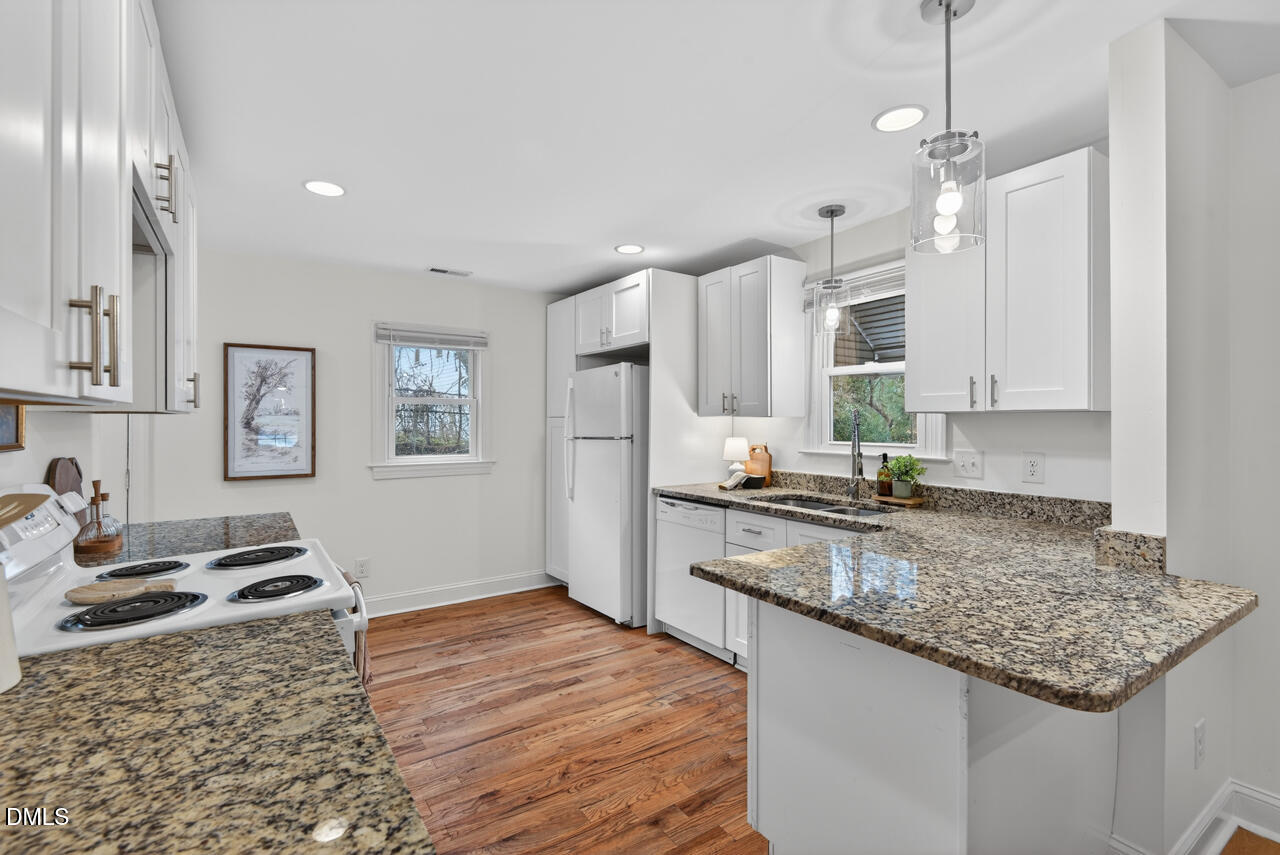 802 Cox Avenue Durham, NC 27701 - Photo 16 of 41 a kitchen with granite countertop a sink stainless steel appliances and cabinets