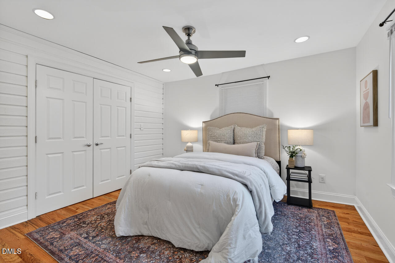 802 Cox Avenue Durham, NC 27701 - Photo 20 of 41 a bedroom with a bed and wooden floor