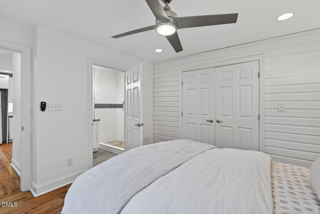 802 Cox Avenue Durham, NC 27701 - Photo 21 of 41 a bedroom with a bed and a chandelier