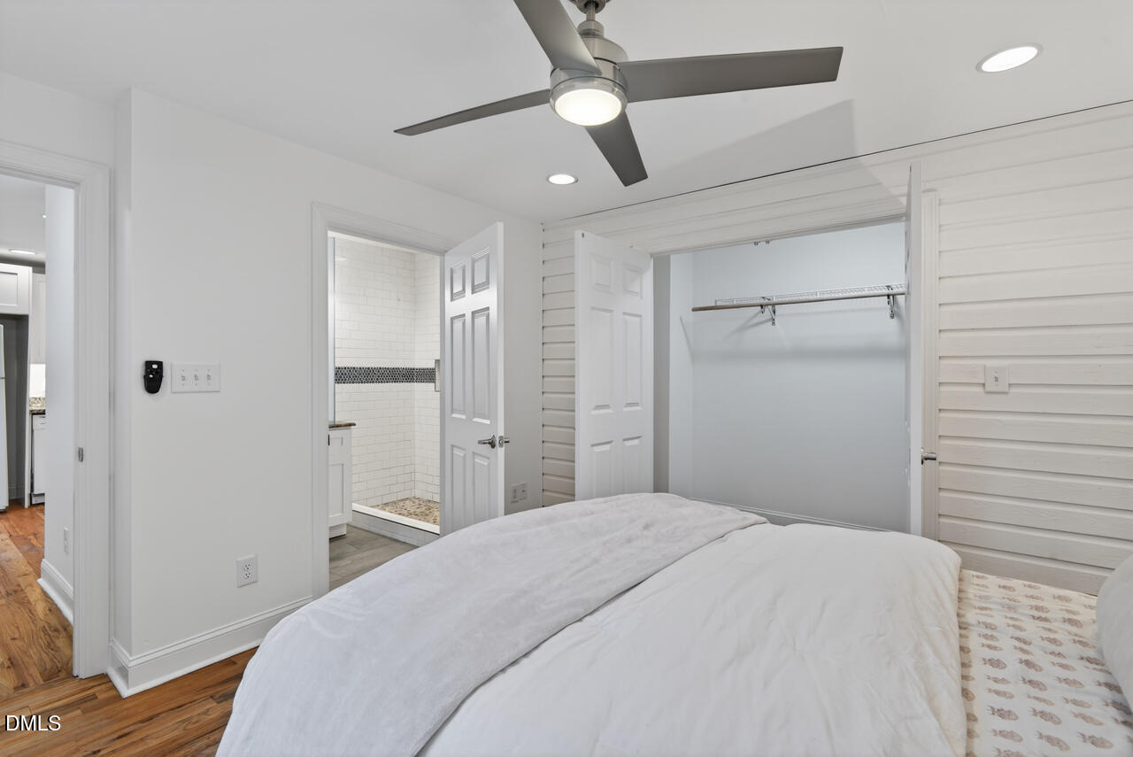 802 Cox Avenue Durham, NC 27701 - Photo 22 of 41 a bedroom with a bed and a chandelier