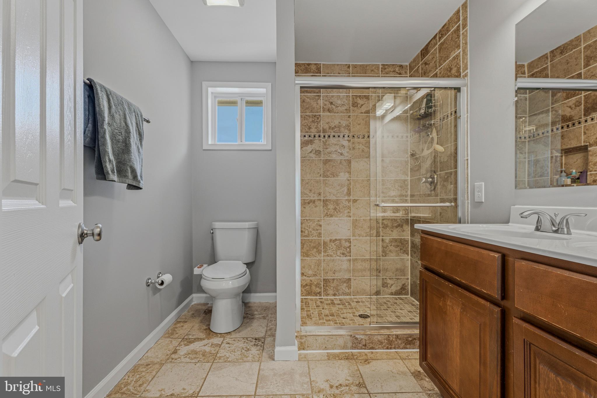 506 Brook Road Baltimore, MD 21286 - Photo 21 of 56 a bathroom with a granite countertop sink a toilet and shower