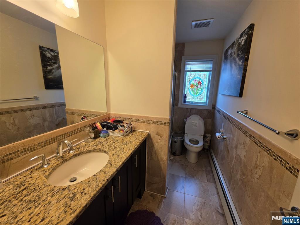 527 Roff Avenue, Unit B Palisades Park, NJ 07650 - Photo 11 of 11 a en suite bathroom with a granite countertop sink and a mirror