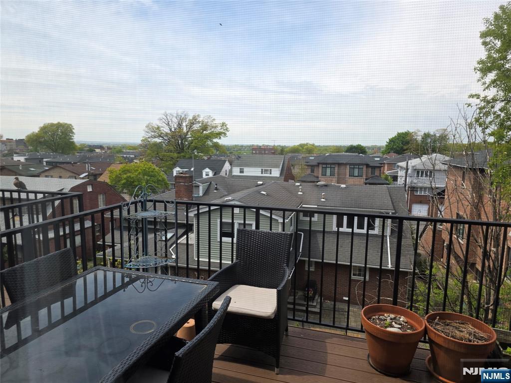 527 Roff Avenue, Unit B Palisades Park, NJ 07650 - Photo 5 of 11 a view of a balcony with chair and wooden floor