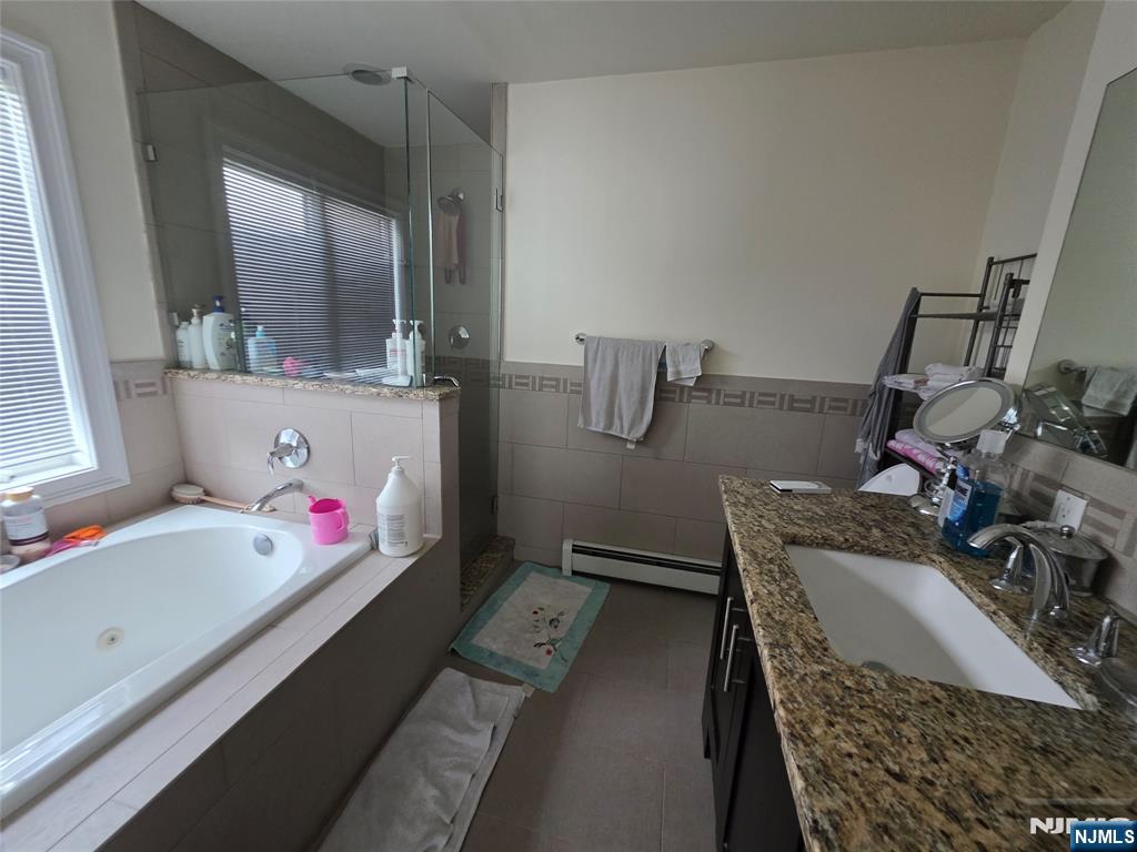 527 Roff Avenue, Unit B Palisades Park, NJ 07650 - Photo 7 of 11 a bathroom with a tub sink and mirror