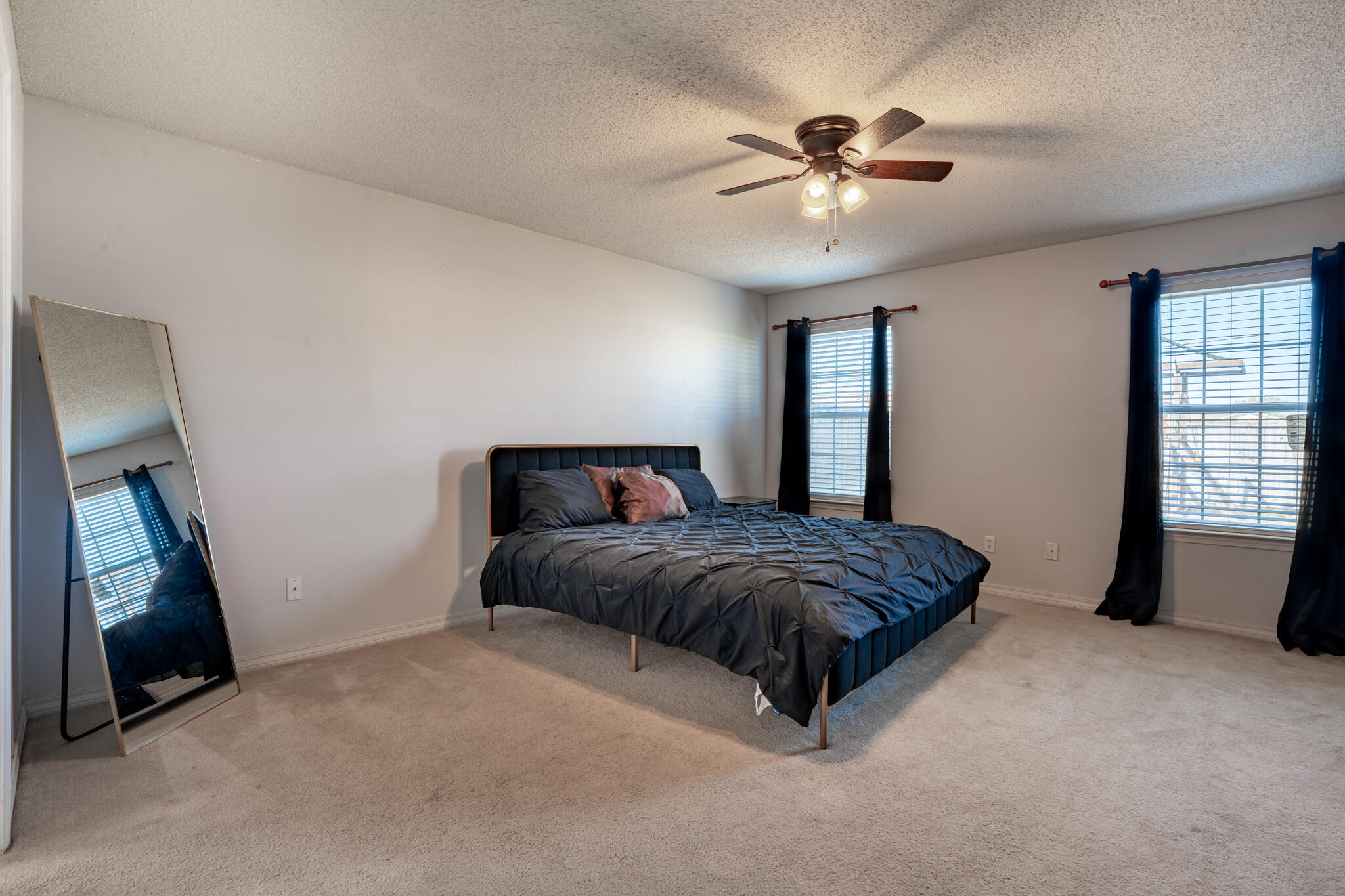 104 Sandstone Trail Crestview, FL 32539 - Photo 18 of 41 a spacious bedroom with a bed and a chandelier