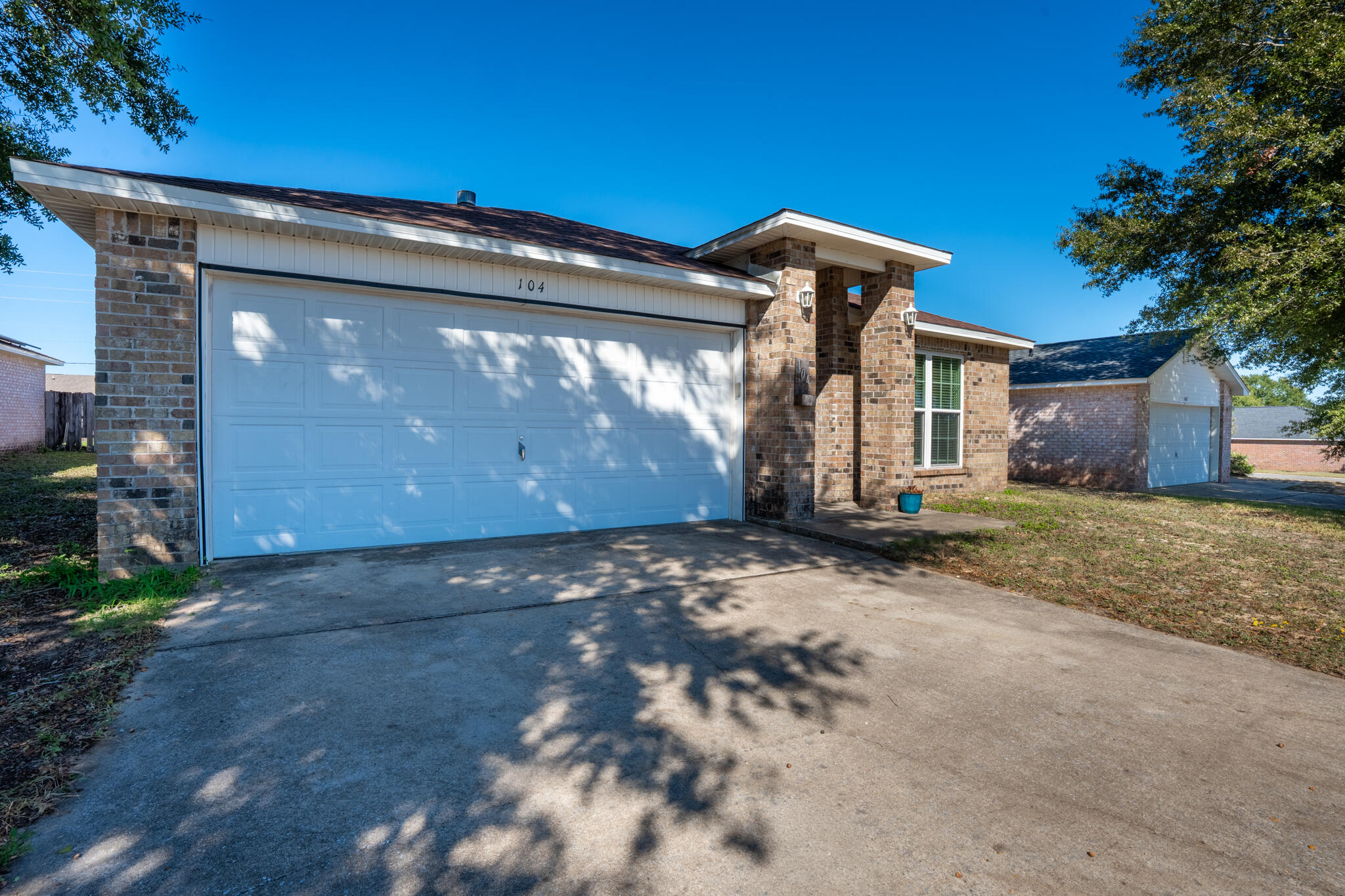 104 Sandstone Trail Crestview, FL 32539 - Photo 2 of 41 a view of a house with a yard and garage