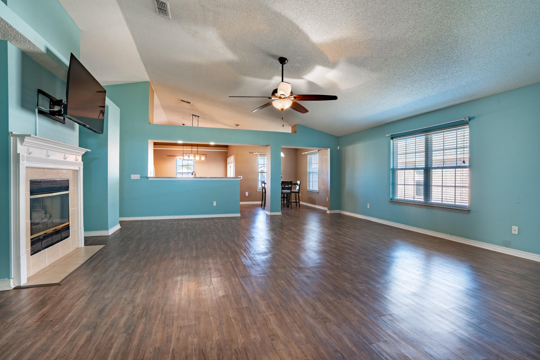 104 Sandstone Trail Crestview, FL 32539 - Photo 6 of 41 an empty room with wooden floor fireplace and windows