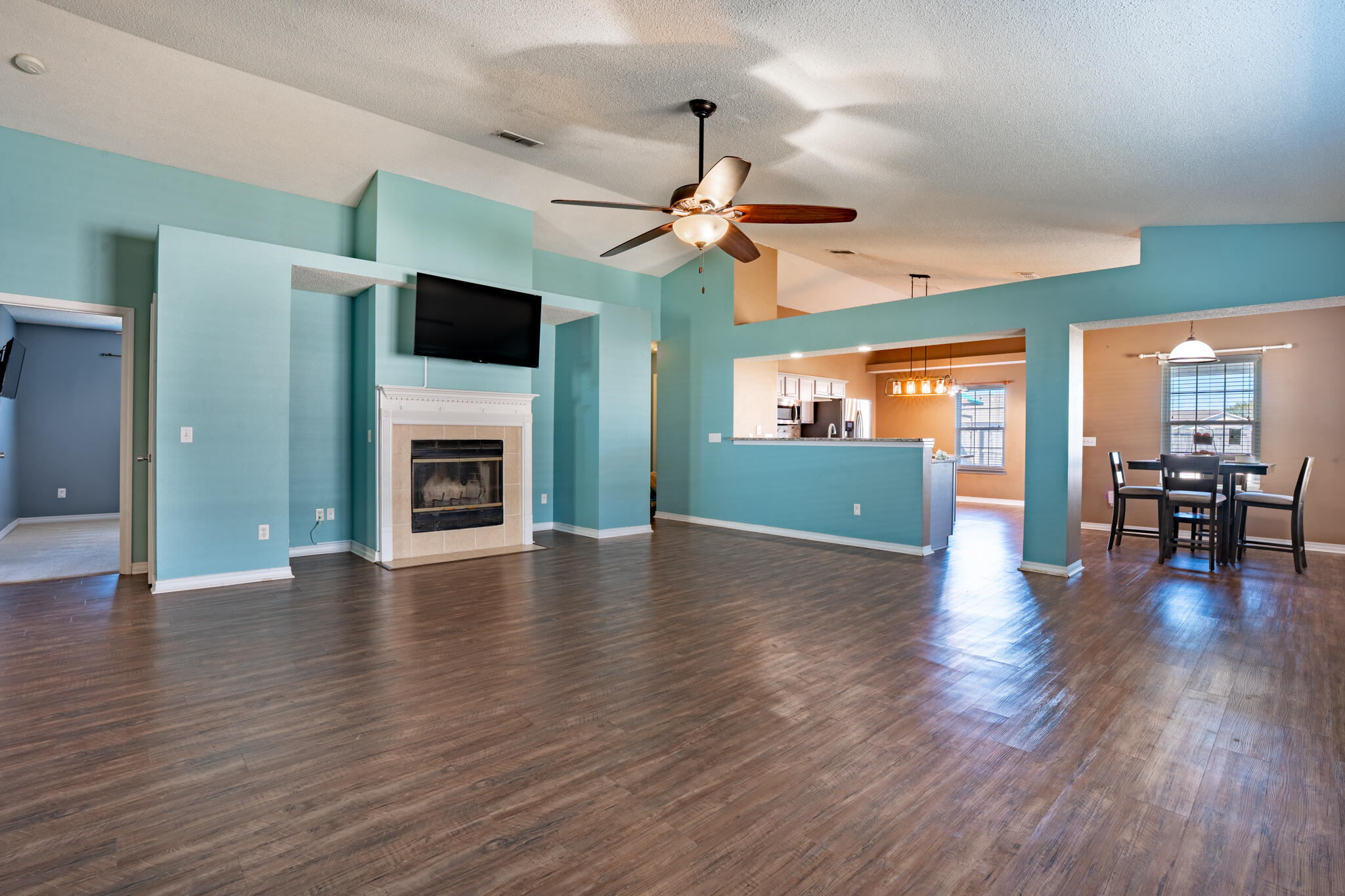 104 Sandstone Trail Crestview, FL 32539 - Photo 8 of 41 a view of an empty room with wooden floor a fireplace and a window