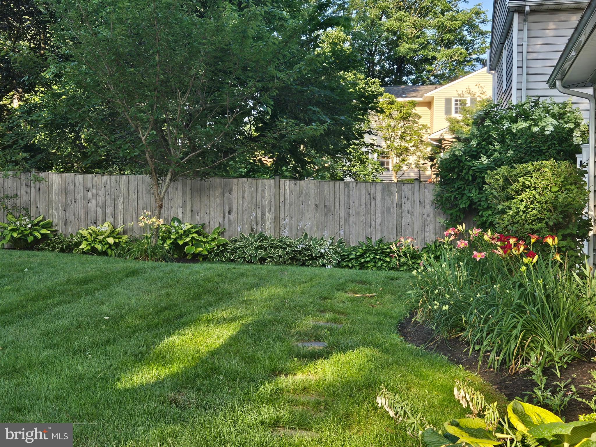 19321 Olney Mill Road Olney, MD 20832 - Photo 13 of 91 a view of a backyard with potted plants and wooden fence