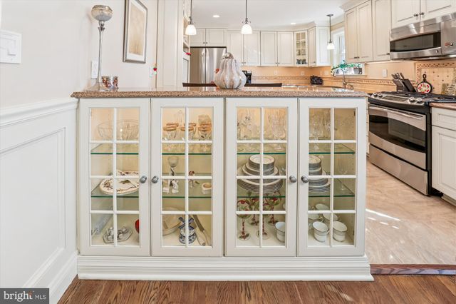 a view of bathroom with a toilet a sink and mirror